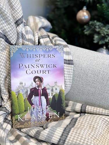 Book cover of Whispers at Painswick Court resting on a plaid blanket.
