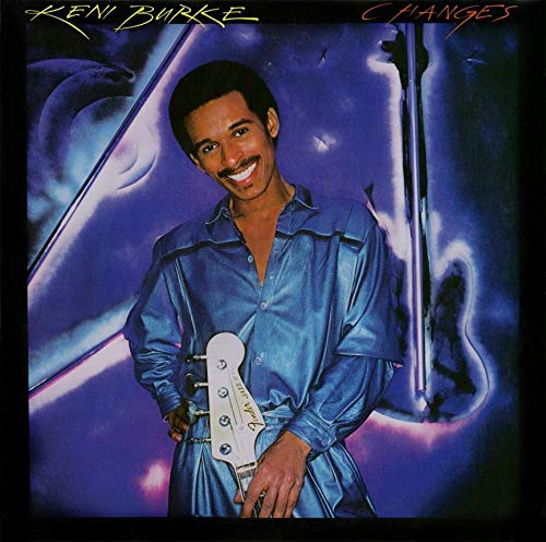 Keni Burke album cover, portrait of a smiling man with a bass guitar.