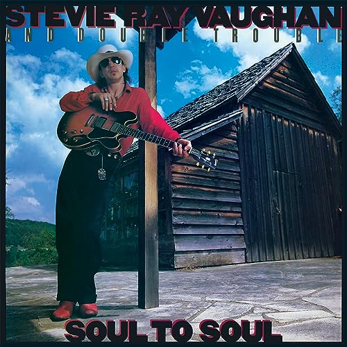 Stevie Ray Vaughan album cover, featuring him with a guitar by a shack.