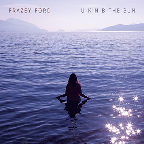 CD cover: person in water with mountains and sparkling lights.