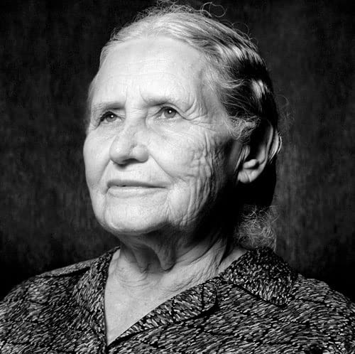 Black and white portrait of an elderly woman with wrinkled skin.