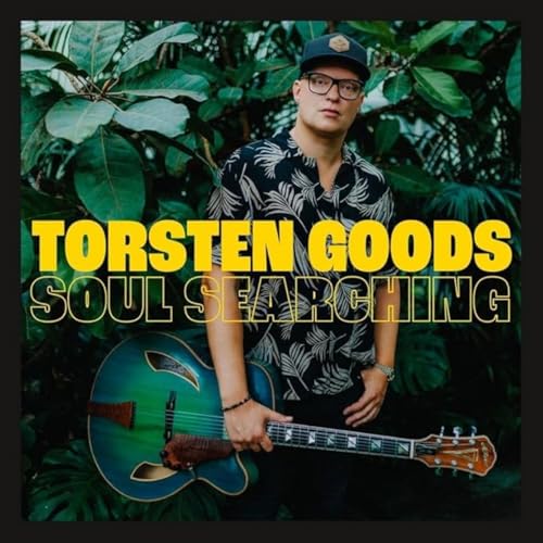 CD cover: man with guitar amidst lush green foliage.