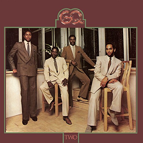 GQ’s “Two” album cover: four men in suits pose indoors.