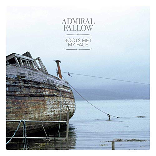 Album cover: derelict boat on water under a cloudy sky.