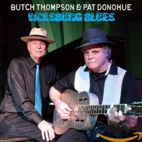 Butch Thompson and Pat Donohue wearing hats, with one playing a resonator guitar.