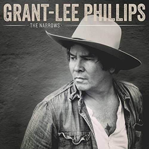 BlackHazy black and white photo of Grant-Lee PhillipsLH Phillips wearing a wide-brimmed hat.