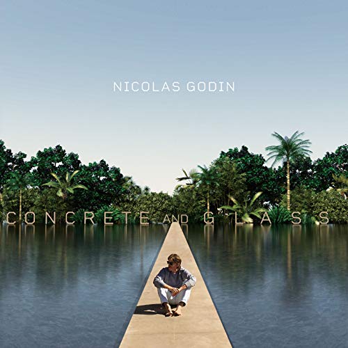 Album cover: man sitting on a concrete path by water and trees.