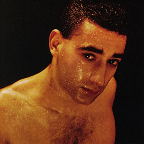 Close-up portrait of a sweaty man with dark hair and intense gaze.