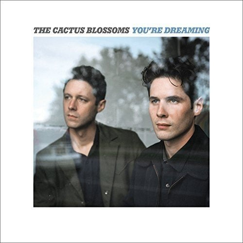 Album cover featuring two men seen through a glass window with text above.