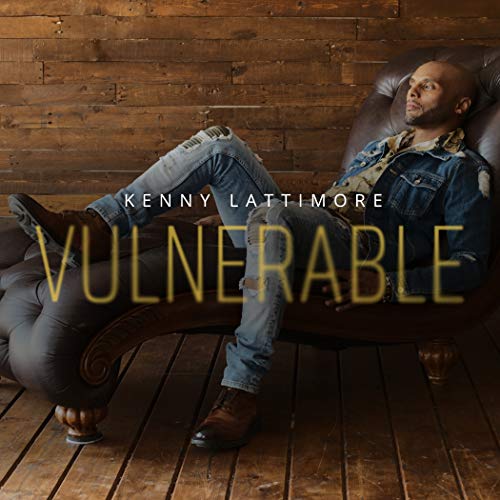 Kenny Lattimore reclines in a leather chair, album cover for "Vulnerable".
