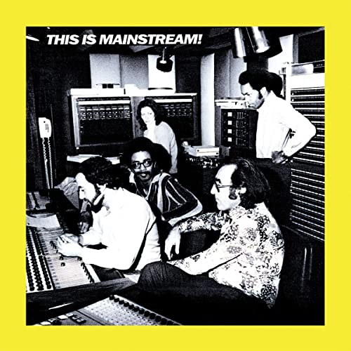 Black and white photo of musicians in a recording studio.