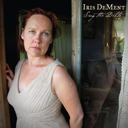 CD cover: Iris Dement portrait in a doorway, soft focus.