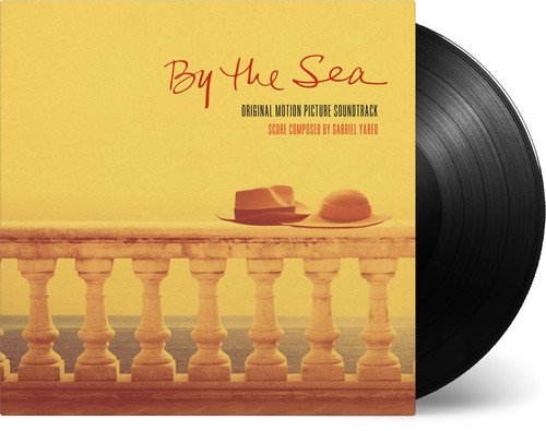 “By the Sea” soundtrack vinyl record with yellow cover and two hats.