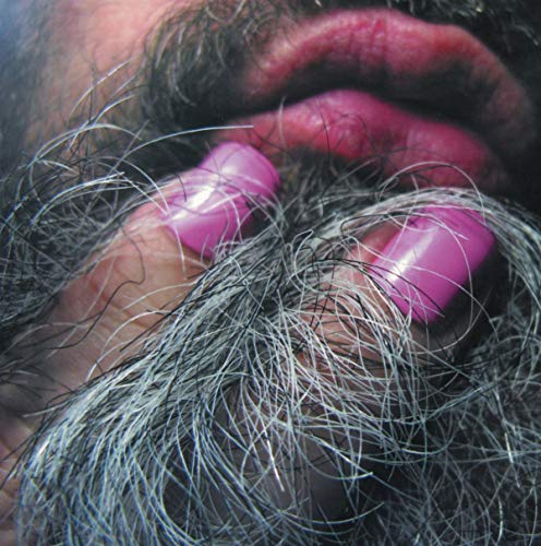 Close-up of a bearded face with bright pink fingernails.