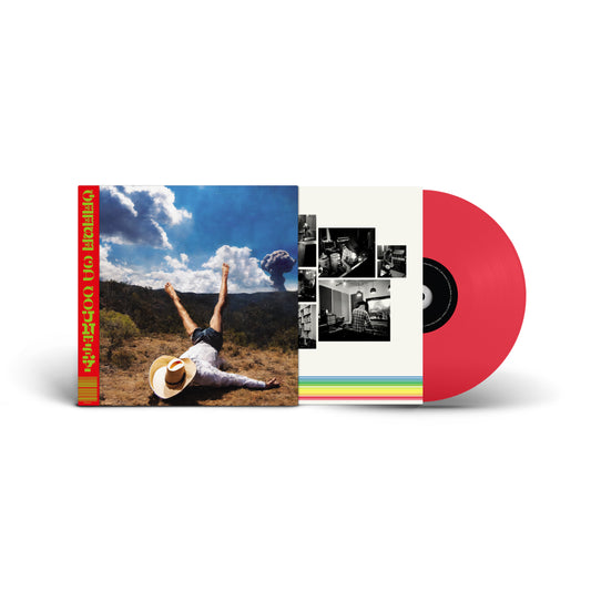 Red vinyl record with album cover featuring a person in a field.