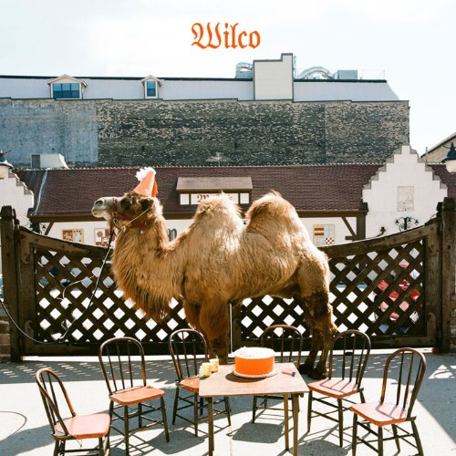 Wilco album cover featuring a camel with a party hat and cake.