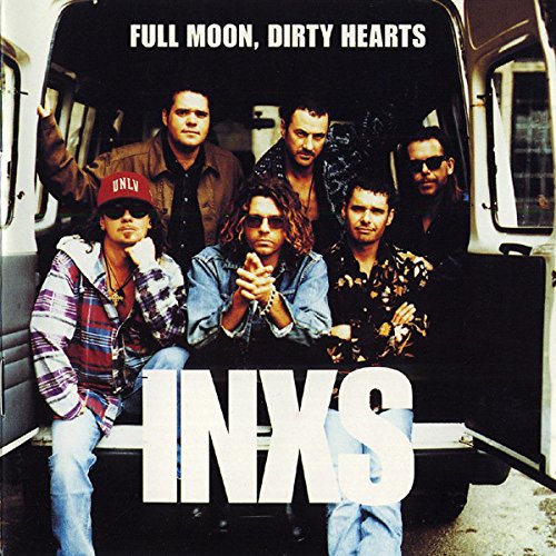 INXS band members posing inside an open van doorway, album cover.
