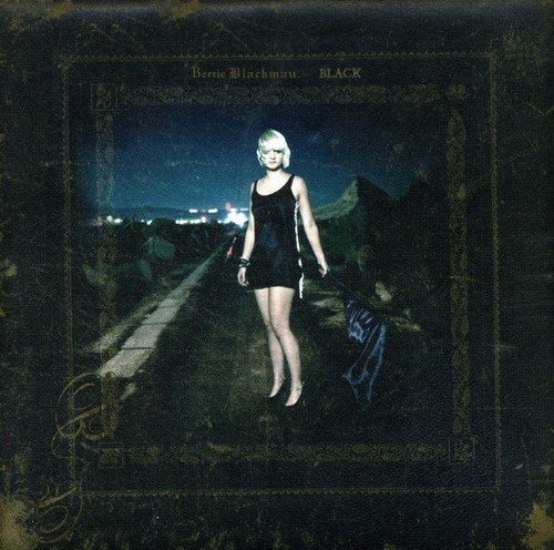 CD cover: Bertie Blackman, a woman in black, standing on a road.