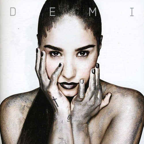 Demi Lovato album cover: close-up portrait with silver paint and dark makeup.