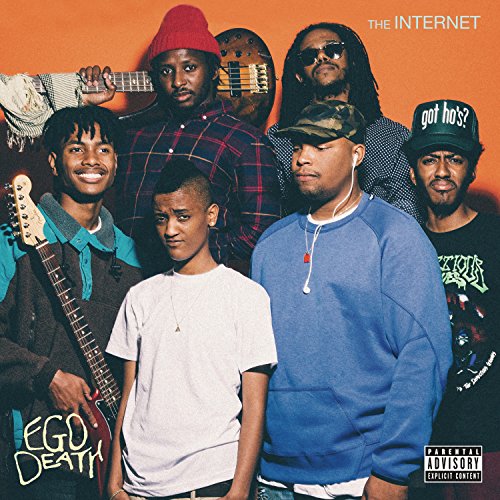 Six men with varied expressions and casual clothing, album cover.