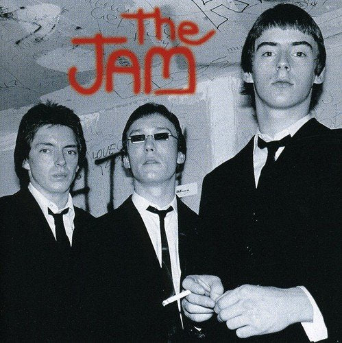 Black and white album cover featuring The Jam band members in suits.