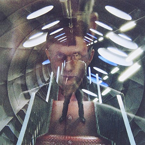 Surreal album art featuring a man's face overlaid on a futuristic tunnel corridor.