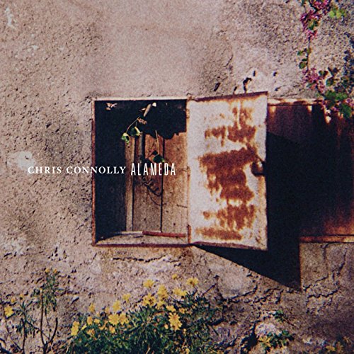 CD cover: weathered wall with open, rusty doorway and flowers.
