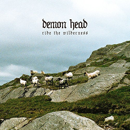 CD cover: rocky hillside with sheep under a cloudy sky.