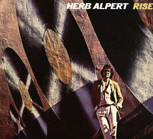 Herb Alpert’s “Rise” album cover: man in a modern architectural space.