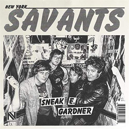 Black and white photo of four people in front of record store shelves.
