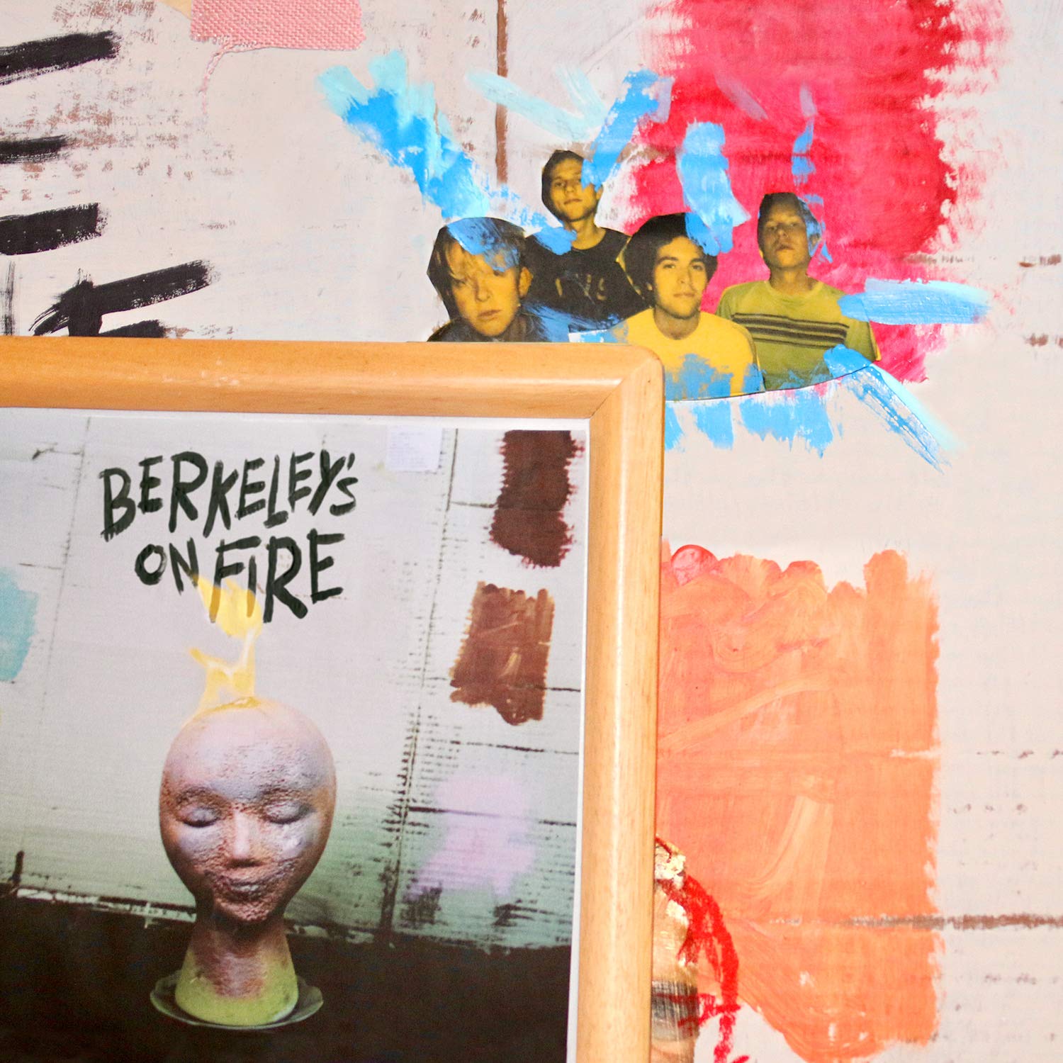 CD album cover with painted figures and a sculpted head.