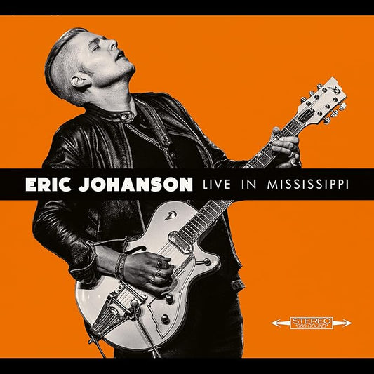 Eric Johanson playing a silver guitar on CD cover, orange background.