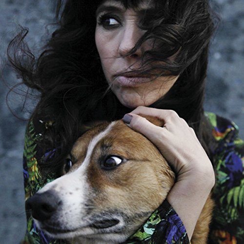 Woman with long dark hair embracing a brown and white dog.