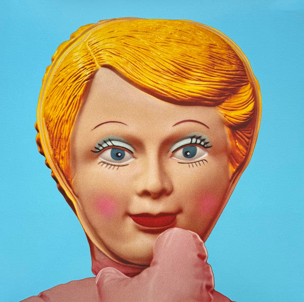 Close-up portrait of a woman with exaggerated makeup and a finger over lips.