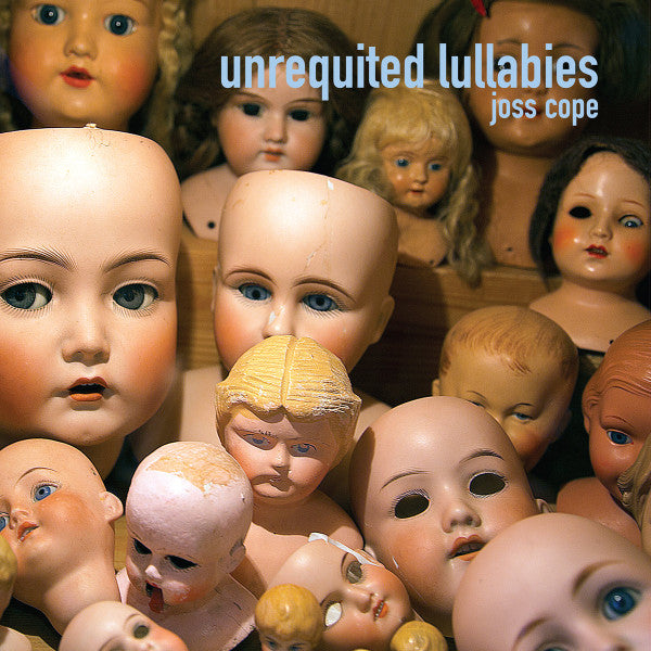 Album cover featuring a dense collection of vintage porcelain doll heads.