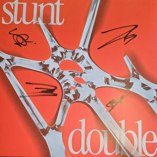 Orange album cover with abstract silver shapes and handwritten signatures.