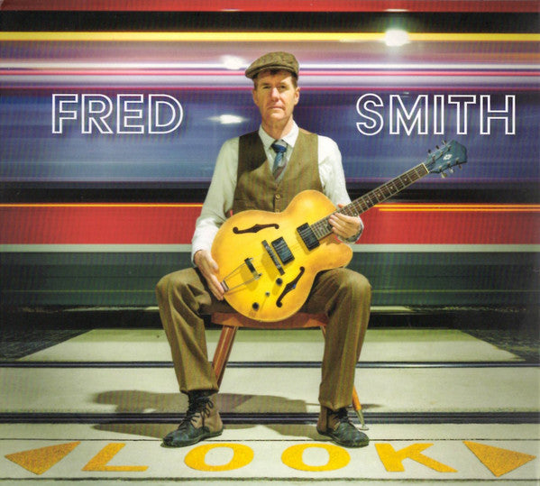 Fred Smith seated with a guitar, album cover for "Look.