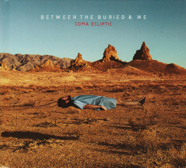 DVD cover for "Coma Ecliptic" featuring a person lying in a desert landscape.