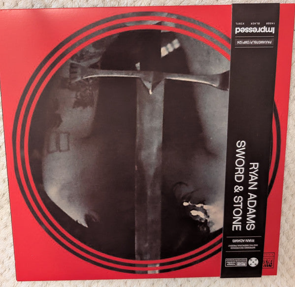 Ryan Adams' "Sword & Stone" vinyl record with a knight illustration.