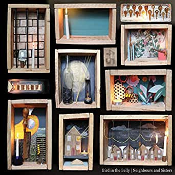 CD cover featuring nine small, illuminated shadowbox-style art pieces.