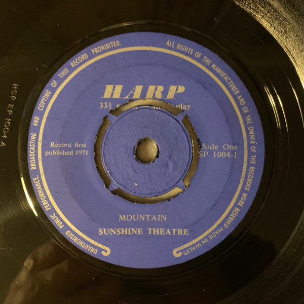 Purple vinyl record label with "Sunshine Theatre - Mountain" text and central spindle hole.