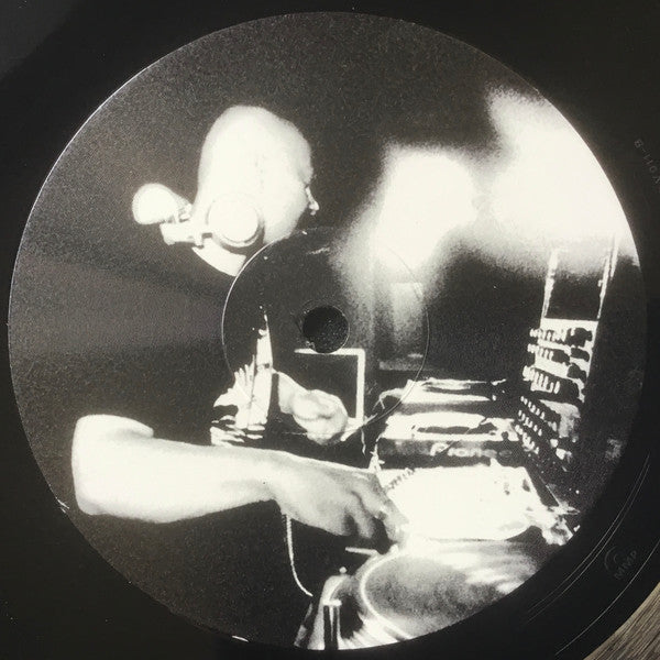 Black and white vinyl record featuring a portrait of a man with headphones.
