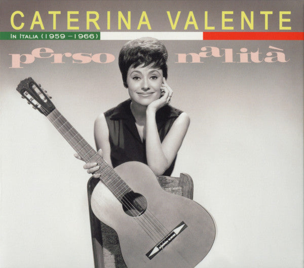 Black and white portrait of Caterina Valente with a guitar.
