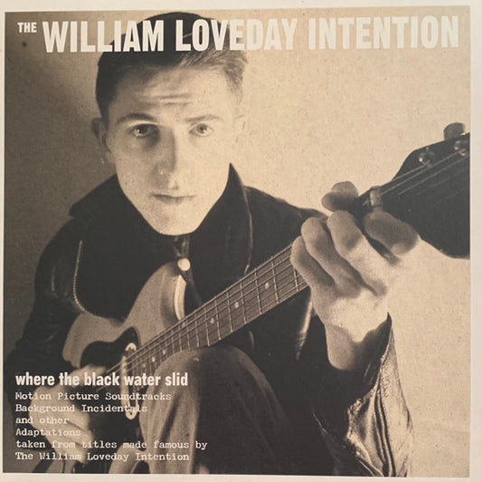 Black and white vinyl album cover featuring a man with a guitar.