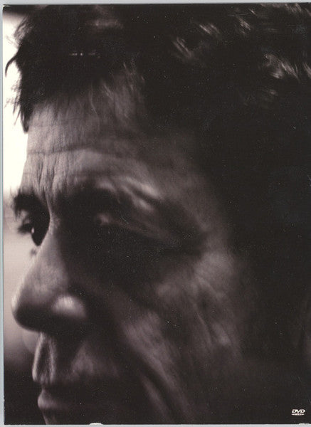 Black and white close-up of a man’s face, partially in shadow.