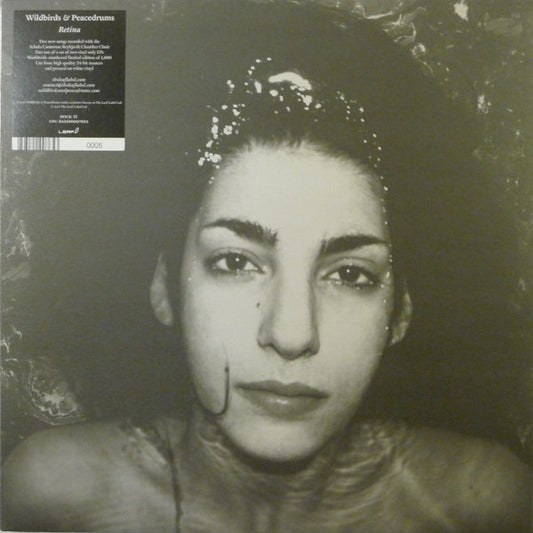 Black and white vinyl record cover featuring a close-up portrait of a woman.