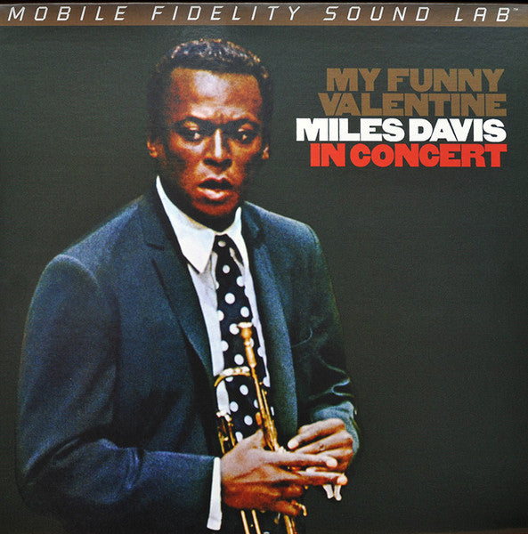Miles Davis portrait on vinyl record cover, holding a saxophone.