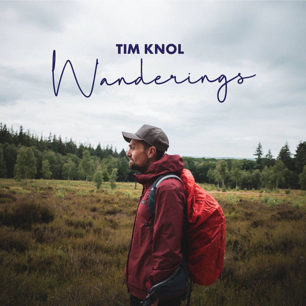 Album cover: man with red backpack in a moorland landscape.