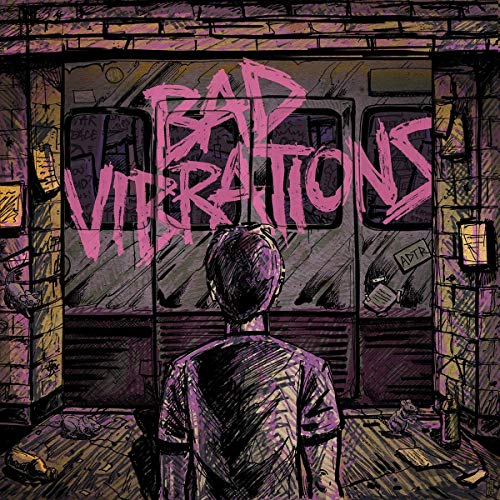 A person stands before a subway train with Bad Vibrations spray-painted in pink.