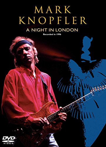 Mark Knopfler wearing a headband and red shirt playing guitar on a dark background.